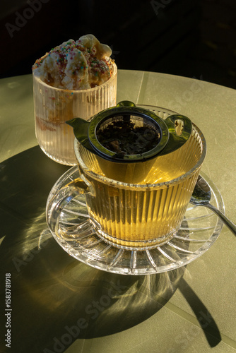 Sunlit Tea and Ice Cream Dessert on Table