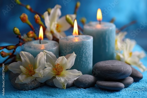 Serenity and tranquility are captured with glowing candles, smooth stones, and delicate flowers arranged beautifully for a calming experience