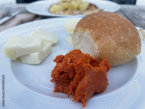 Traditional Italian appetizer with crusty bread topped with melted provola cheese and spicy Calabrian ’nduja