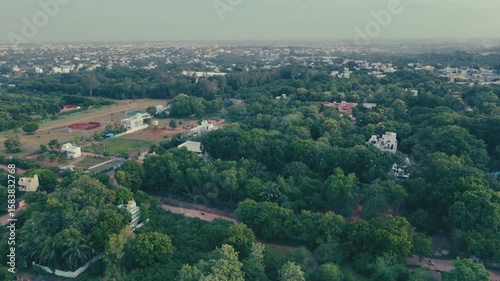 Aerial view of Pondicherry , India featuring a blend of dense green trees and scattered buildings