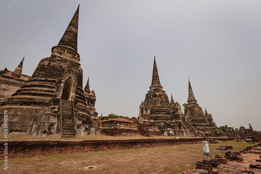 Fototapeta premium Ancient buddhist sputas in the old Thai capital Ayutthaya in Thailand