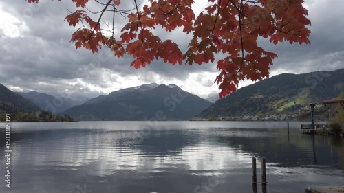 Lake Zell with red foliage swaying in autumn and Kitzsteinhorn in the background