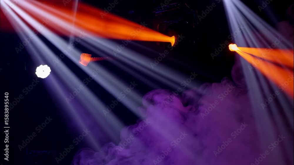 Dramatic stage lighting with colorful spotlights and ethereal smoke, creating an exciting atmosphere for a live concert or performance.