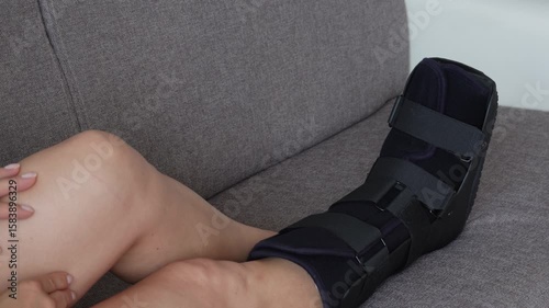 Fractured female leg in orthopedic medical fracture Walker boot tall foot ,support splint foot stabilize,for ankle trauma and tendon lesions. Orthopedic shoes woman and man.