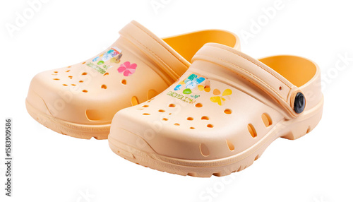 Pair of peach children's crocs showing floral decoration on transparent background