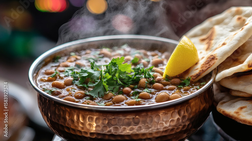 Egyptian ful medames in copper bowl with pita bread