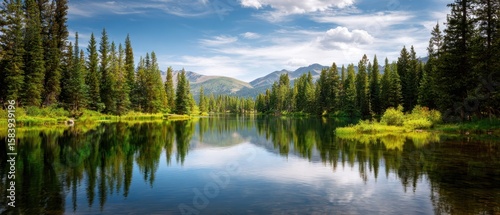 The serene lake reflecting the majestic mountains and lush forest landscape.