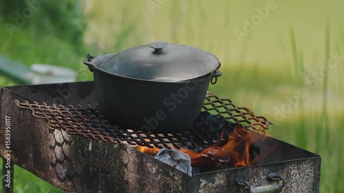 Cooking fish soup outdoors in summerIn a cauldron on a grill