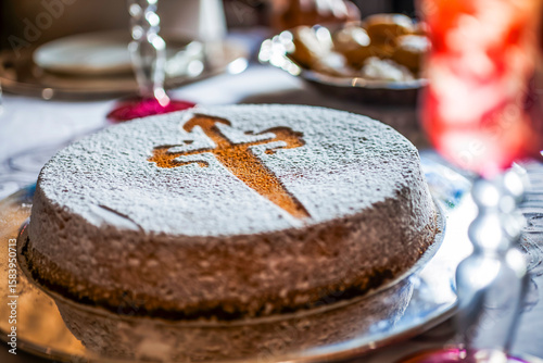 Santiago cake decorated with icing sugar cross of saint james