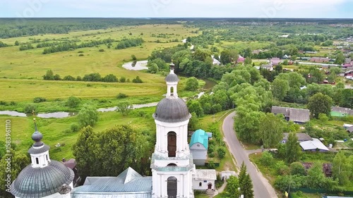 Landscape with orthodox church with fields under gloomy sky