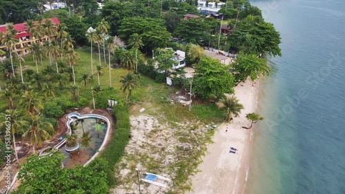 Drone view of amazing white sand beach blending with turquoise waters, palm trees