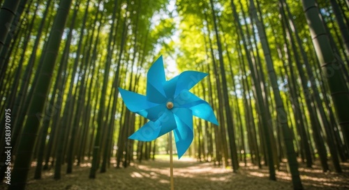 A blue pinwheel stands in a bamboo forest, blades facing forward.