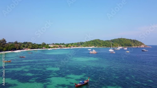 aerial view of beautiful crystal clear water and white sand beach with long tail boats