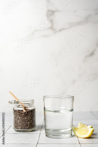 Glass of water full of chia seeds with slices of lemons