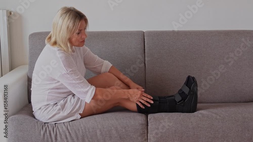 Fractured female leg in orthopedic medical fracture Walker boot tall foot ,support splint foot stabilize,for ankle trauma and tendon lesions. Orthopedic shoes woman and man.