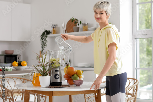 Sporty young woman pouring ...