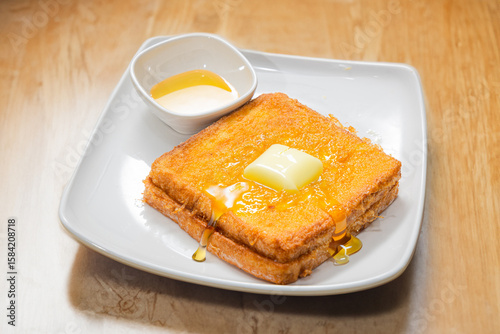 A classic Hong Kong style deep fried delicacy served at traditional cha chaan teng afternoon tea French toast drizzled with golden syrup