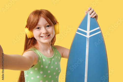 Cute girl in headphones wit...