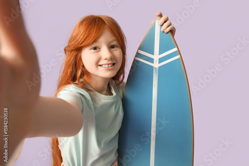 Cute girl with surfboard ta...