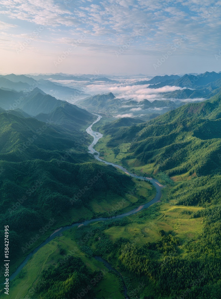 Fototapeta premium Misty mountain valley with winding river