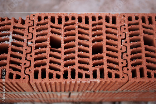 Close-up of hollow bricks from above, showing internal structure designed for insulation and energy efficiency in eco-conscious home construction.