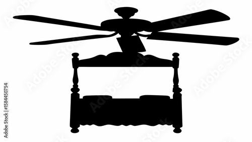 Silhouette of a four poster bed with pillows and a ceiling fan above it in a bedroom setting
