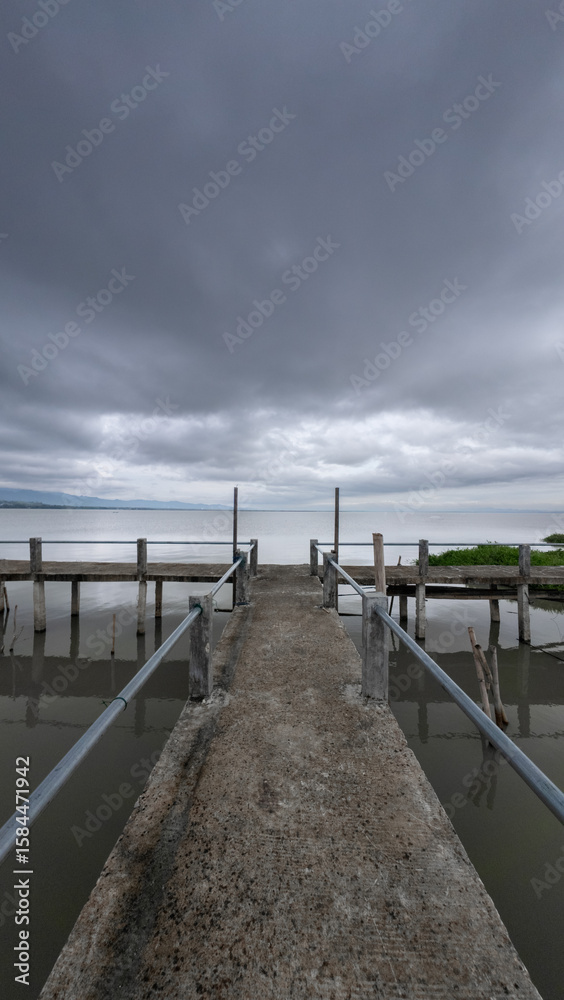Obraz premium Concrete Pier Under Cloudy Sky