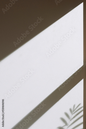 Concrete texture background with shadows from natural light streaming through a window.