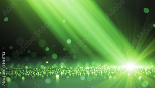 Green light rays with glowing particles create vivid and dynamic abstract background full of energy and brightness