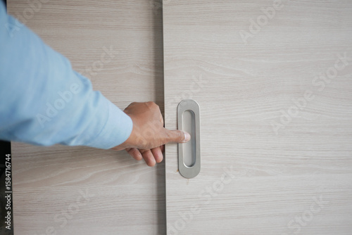 Obraz na płótnie Hand opening a sliding door in modern interior design