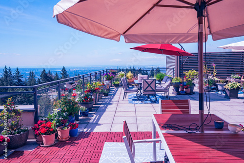 Bild auf Leinwand Multiple umbrellas on large Burnaby Mountain penthouse patio overlooking Fraser Valley, BC, Canada, during summer