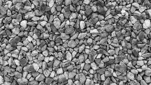 Canvas Print monochrome gravel stones in top view with rough and uneven surface