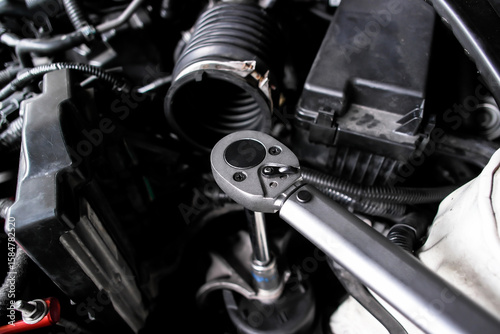 Schilderij op canvas Torque wrench in use, auto repair or car maintenance and engine work with mechanic tool, automotive service