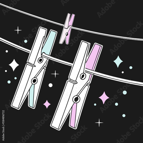 Colorful clothespins hanging on a line against a black background  