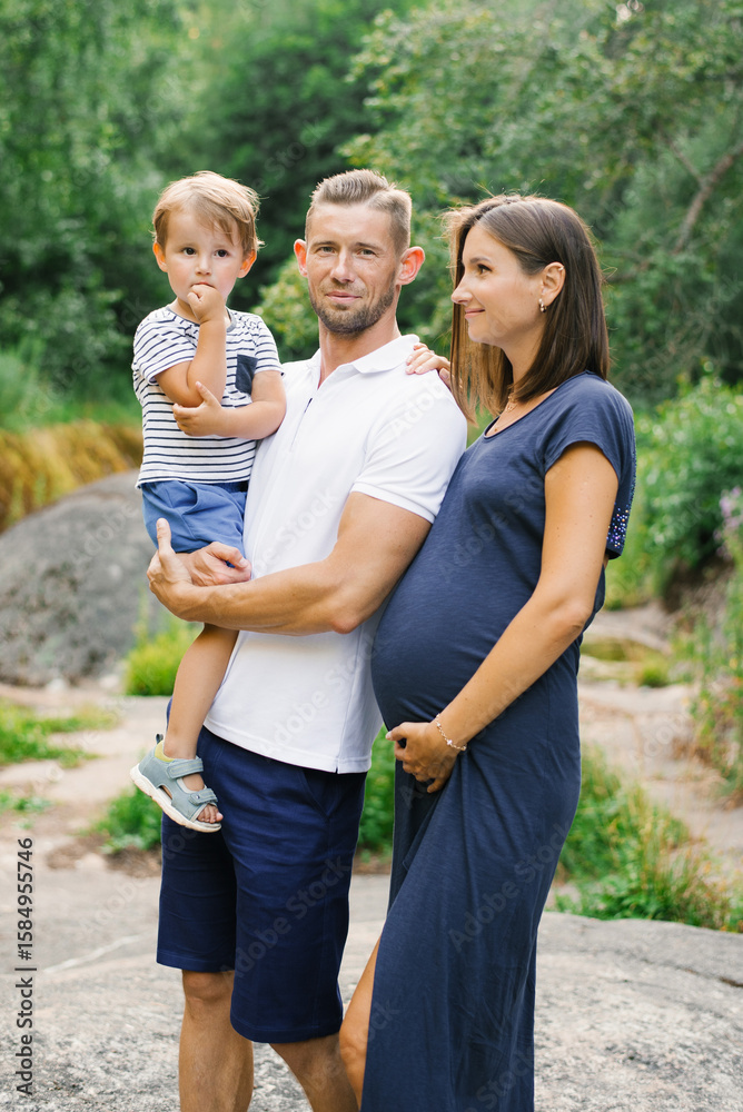 Fototapeta premium Happy Family Posing Together In Summer Forest With Greenery