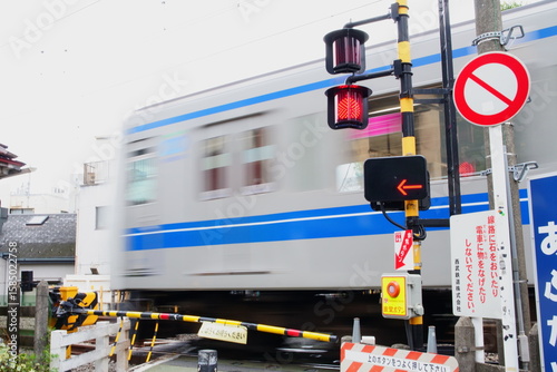 Fototapeta Naklejka Na Ścianę i Meble -  Tokyo: Train Passing Small Railroad Crossing (Daily Scene)