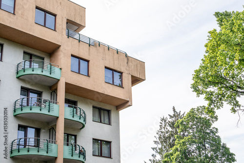 Modern Apartment Building with Balconies and Trees in a Residential Urban Neighborhood