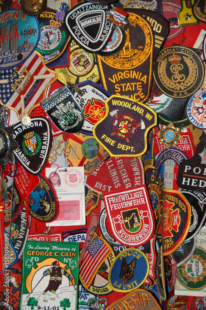 Fototapeta premium Colorful collection of police and fire department patches from around the world displayed together as a tribute to first responders and their service