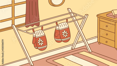A pair of red and white patterned mittens are drying on a portable rack indoors.