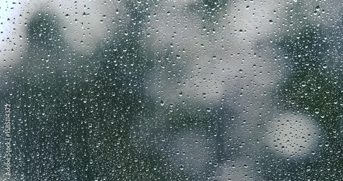 rainy days, heavy rain falling on the window surface , with thunder