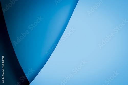 Abstract light and dark blue background with elegant flowing curved lines, creating a minimalist and modern sense of space