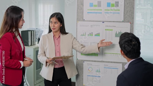 Businesswomen leading a presentation on financial charts in office