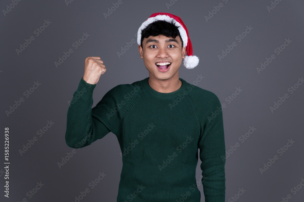 Portrait of Excited Young Asian Man Wearing Santa Hat, Christmas Holiday Concept Portrait of Excited Young Asian Man Wearing Santa Hat, Christmas Holiday Concept