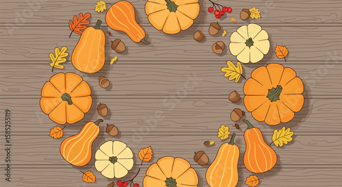 Autumn harvest wreath decoration with gourds leaves and acorns arranged on wooden background