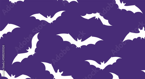 Spooky white bats flying on a dark purple background for halloween