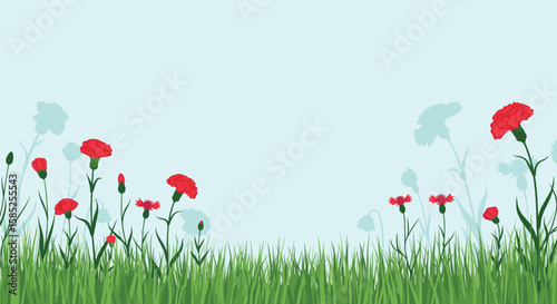 Vibrant red carnations bloom amidst lush green grass under a serene blue sky