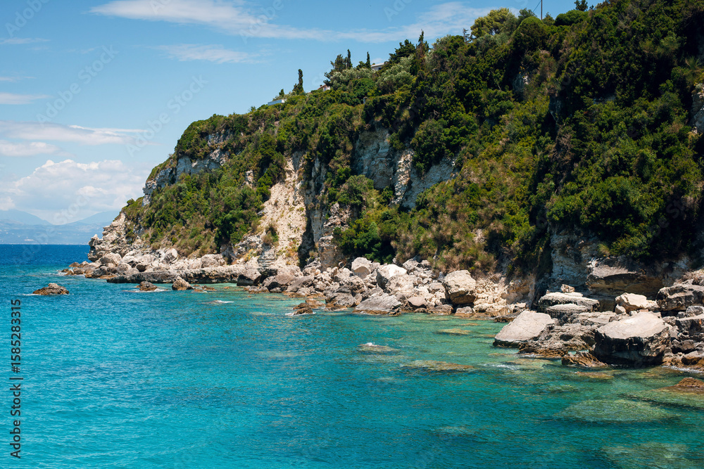 Fototapeta premium Rocky Cliffs and Turquoise Sea Under Clear Sky