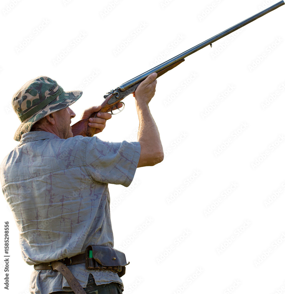 Fototapeta premium Silhouette of a hunter with a gun in the reeds against the sun, an ambush for ducks with dogs