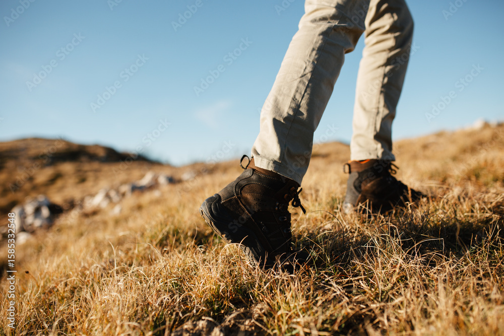 Close up view of hiker boots, walking on the mountain Close up view of hiker boots, walking on the mountain