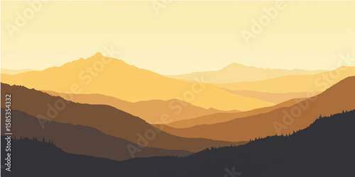 Sunrise paints a majestic mountain landscape, a misty blue silhouette under a clear morning sky